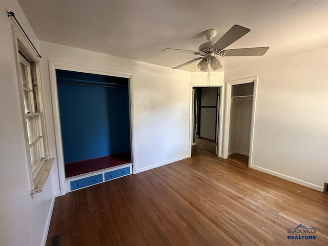 204 3rd Ave, Edgemont, SD 57735 - unfurnished bedroom with wood finished floors, baseboards, and ceiling fan