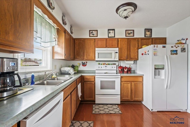 720 S 32nd, Spearfish, SD 57783 - kitchen with white appliances, brown cabinets, a sink, and dark wood finished floors