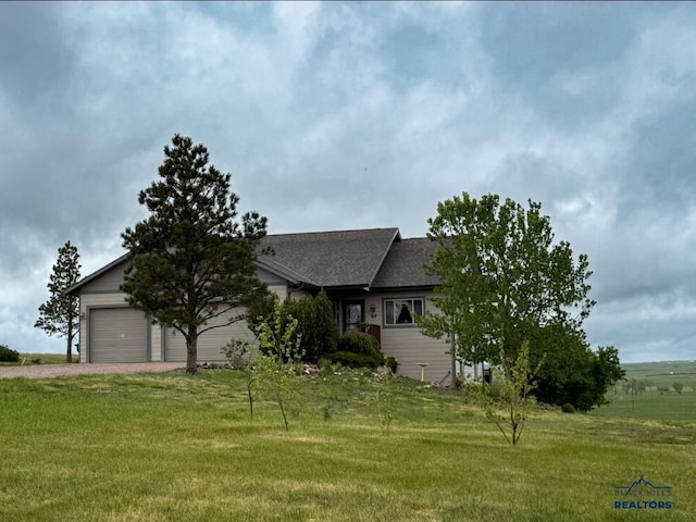 22841 Gateway Dr, Box Elder, SD 57719 - view of front facade featuring a garage, dirt driveway, a front yard, and roof with shingles