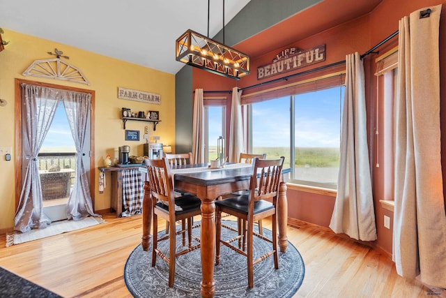 22841 Gateway Dr, Box Elder, SD 57719 - dining room with wood finished floors, a chandelier, and baseboards