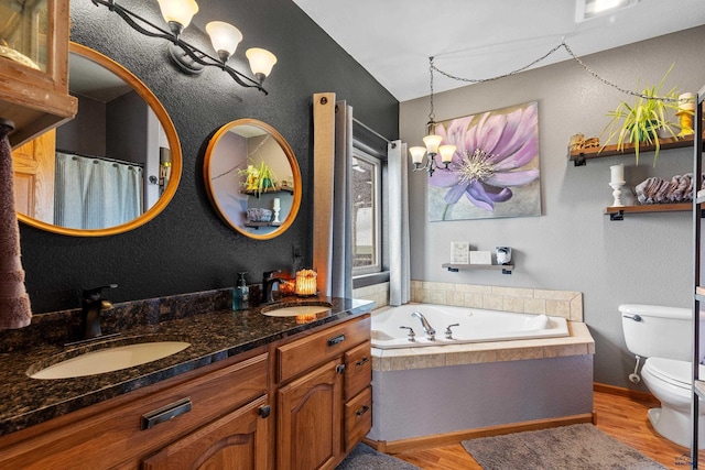 22841 Gateway Dr, Box Elder, SD 57719 - full bath with wood finished floors, a chandelier, toilet, double vanity, and a garden tub