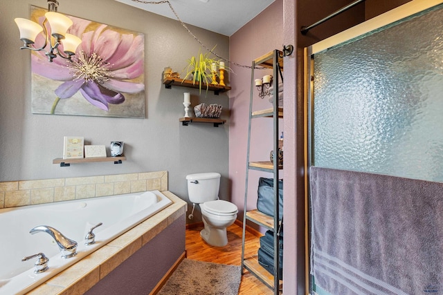 22841 Gateway Dr, Box Elder, SD 57719 - bathroom with toilet, wood finished floors, a garden tub, a chandelier, and a shower