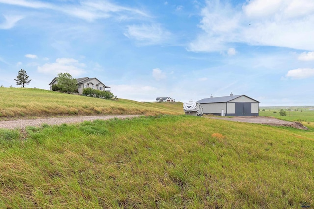 22841 Gateway Dr, Box Elder, SD 57719 - view of green lawn with an outbuilding, a pole building, and a view of rural / pastoral area