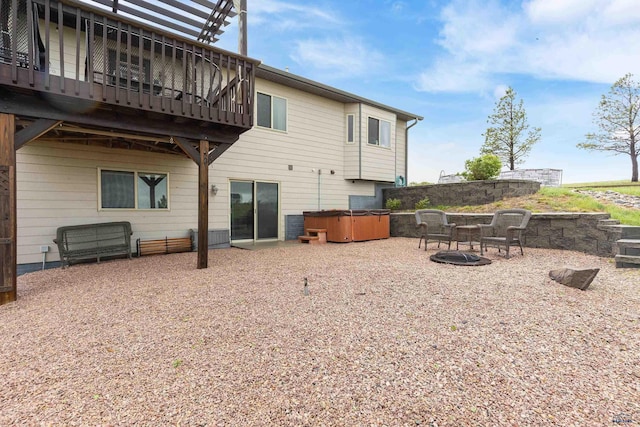 22841 Gateway Dr, Box Elder, SD 57719 - back of house with a hot tub, a deck, and a patio