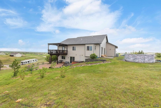 22841 Gateway Dr, Box Elder, SD 57719 - rear view of house featuring a wooden deck, a lawn, and a patio area