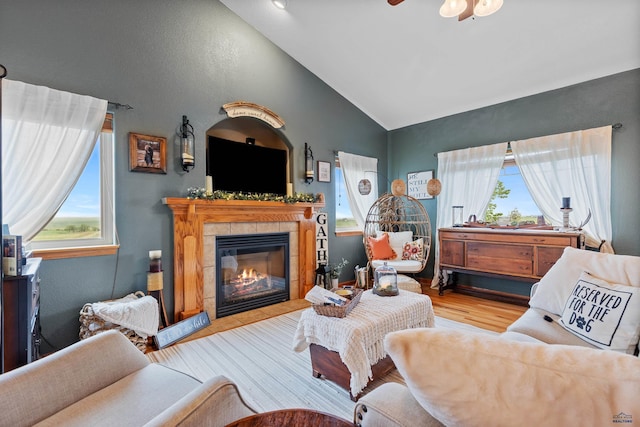 22841 Gateway Dr, Box Elder, SD 57719 - living area with lofted ceiling, a tiled fireplace, wood finished floors, and a ceiling fan