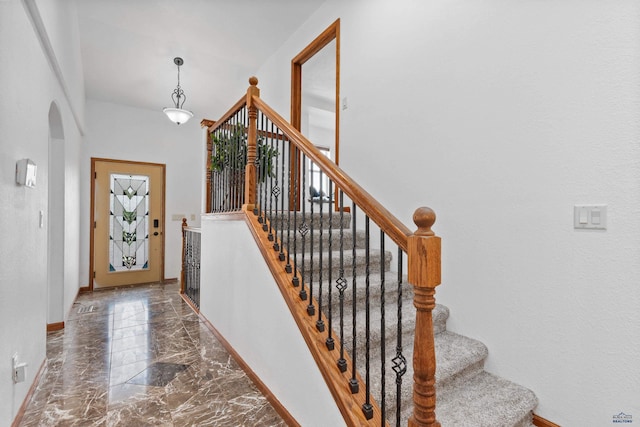 6401 Mountain Meadow Rd, Black Hawk, SD 57718 - entrance foyer featuring marble tiled floors, arched walkways, baseboards, and stairway