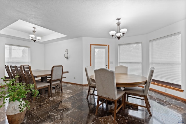 6401 Mountain Meadow Rd, Black Hawk, SD 57718 - dining room featuring a chandelier, baseboards, a tray ceiling, and healthy amount of natural light