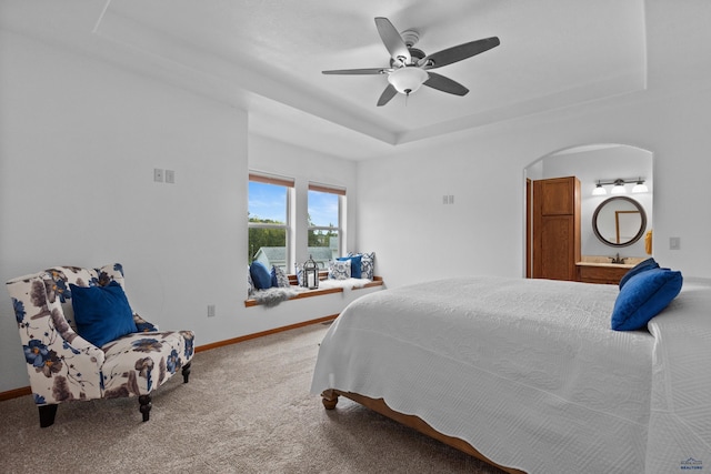 6401 Mountain Meadow Rd, Black Hawk, SD 57718 - bedroom with a tray ceiling, carpet, arched walkways, baseboards, and ceiling fan