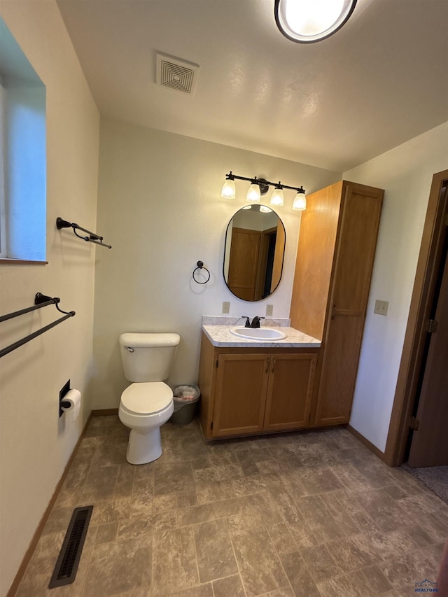 1523 Hope St, Sturgis, SD 57785 - bathroom featuring vanity, baseboards, and toilet
