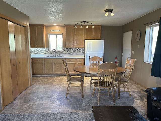 1523 Hope St, Sturgis, SD 57785 - dining area featuring plenty of natural light, a textured ceiling, and light stone finish flooring