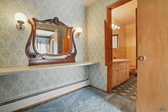 12384 Stannum Pl, Hill City, SD 57745 - bathroom with a baseboard heating unit, toilet, and vanity