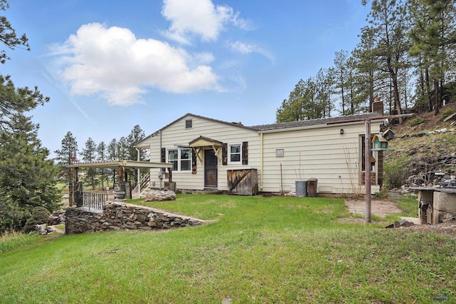 12384 Stannum Pl, Hill City, SD 57745 - back of house featuring a lawn and a chimney