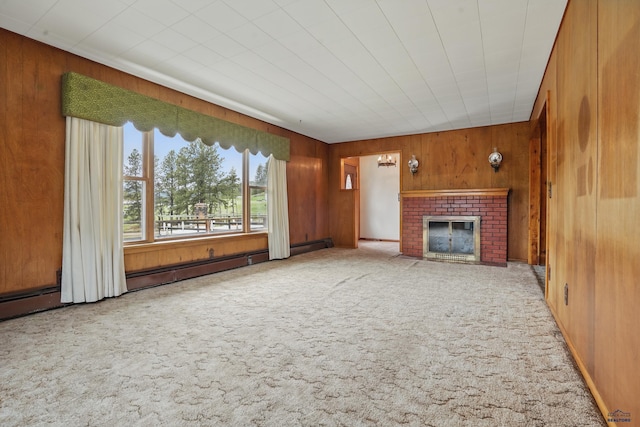12384 Stannum Pl, Hill City, SD 57745 - unfurnished living room featuring carpet, wooden walls, and a brick fireplace