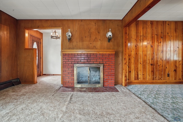 12384 Stannum Pl, Hill City, SD 57745 - unfurnished living room with carpet, wooden walls, a fireplace, baseboard heating, and a chandelier