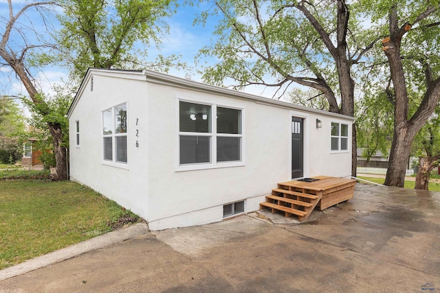 726 Willsie Ave, Rapid City, SD 57701 - view of front of house featuring stucco siding, a front lawn, and a patio area