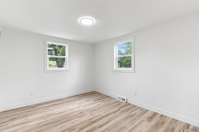726 Willsie Ave, Rapid City, SD 57701 - spare room with healthy amount of natural light, light wood finished floors, and baseboards