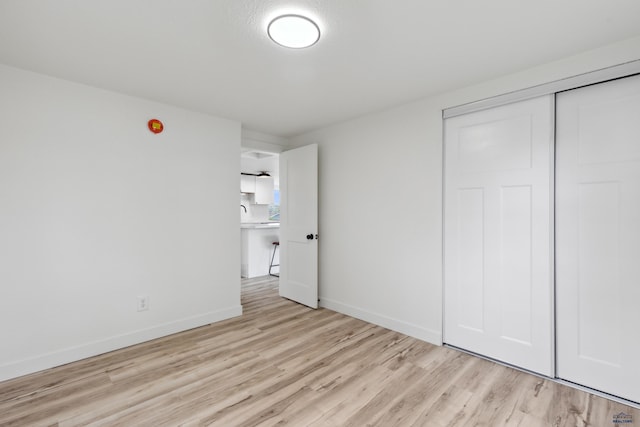 726 Willsie Ave, Rapid City, SD 57701 - unfurnished bedroom with light wood-type flooring, baseboards, and a closet