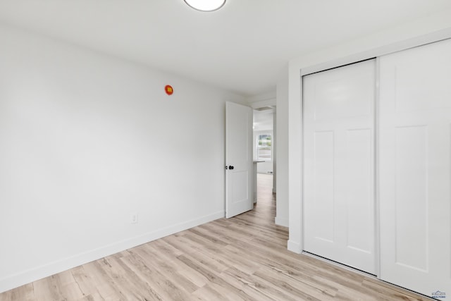 726 Willsie Ave, Rapid City, SD 57701 - unfurnished bedroom featuring light wood-style flooring, a closet, and baseboards