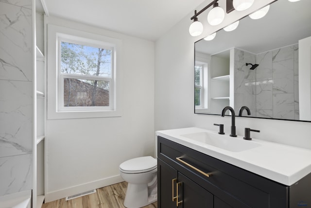 726 Willsie Ave, Rapid City, SD 57701 - full bathroom featuring vanity, a marble finish shower, toilet, and healthy amount of natural light