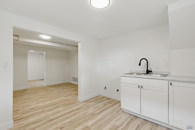 726 Willsie Ave, Rapid City, SD 57701 - bar area with a sink, light wood-type flooring, and baseboards