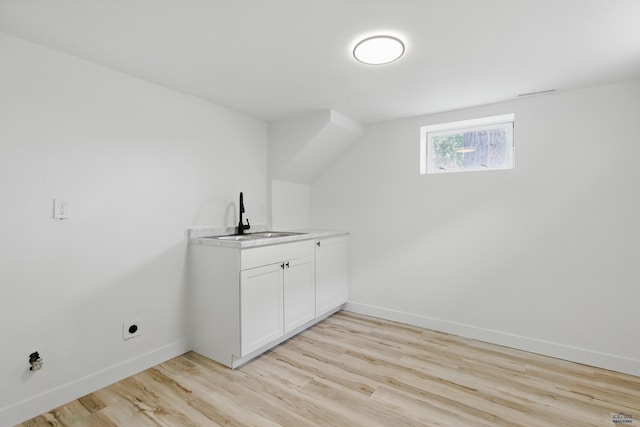 726 Willsie Ave, Rapid City, SD 57701 - washroom featuring a sink, light wood-style flooring, baseboards, and hookup for an electric dryer