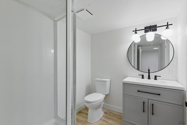 726 Willsie Ave, Rapid City, SD 57701 - bathroom featuring wood finished floors, vanity, toilet, a stall shower, and baseboards