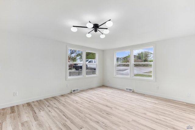 726 Willsie Ave, Rapid City, SD 57701 - empty room featuring a chandelier, wood finished floors, and baseboards