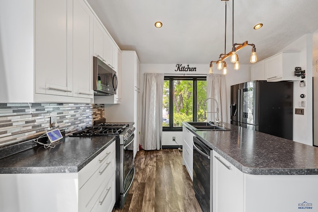 1215 Range View Cir, Rapid City, SD 57701 - kitchen featuring stainless steel appliances, a sink, dark countertops, a kitchen island with sink, and recessed lighting