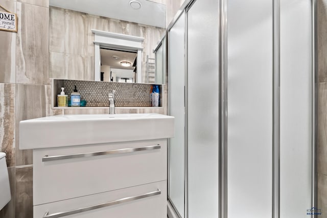 1215 Range View Cir, Rapid City, SD 57701 - bathroom featuring a shower stall, vanity, decorative backsplash, and toilet