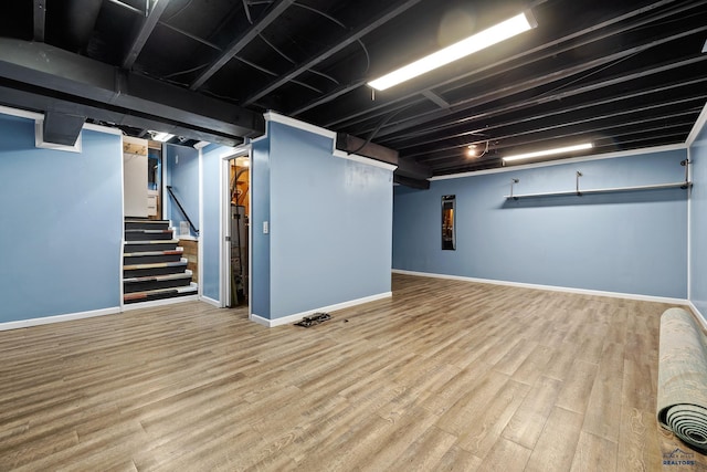 1215 Range View Cir, Rapid City, SD 57701 - finished basement with wood finished floors, baseboards, and stairway