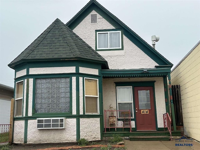 414 2nd Ave, Edgemont, SD 57735 - rear view of property featuring stucco siding, a porch, and roof with shingles