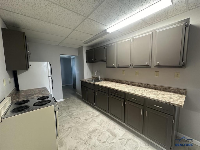414 2nd Ave, Edgemont, SD 57735 - kitchen with white appliances, a drop ceiling, a sink, and baseboards