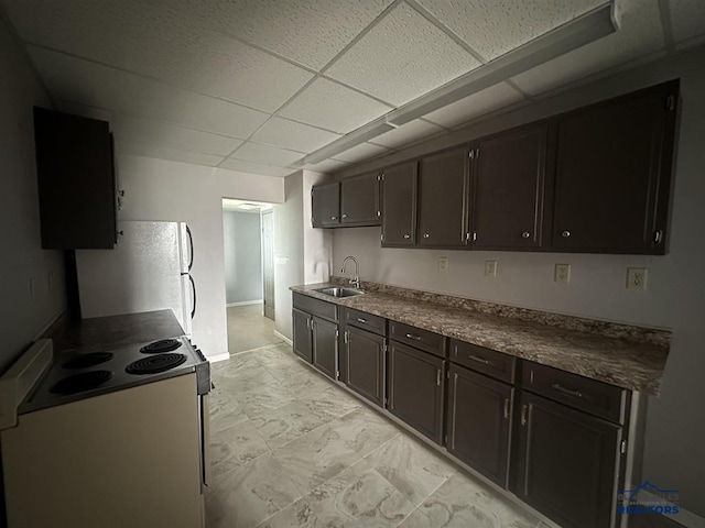 414 2nd Ave, Edgemont, SD 57735 - kitchen with range with electric stovetop, freestanding refrigerator, a sink, a paneled ceiling, and dark countertops