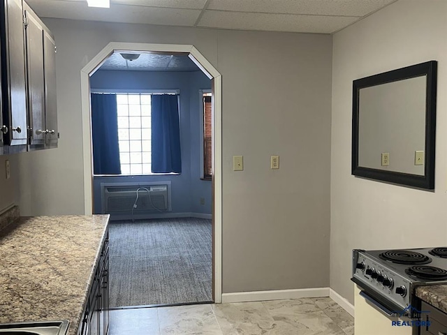 414 2nd Ave, Edgemont, SD 57735 - kitchen featuring range, baseboards, a wall mounted AC, arched walkways, and light countertops
