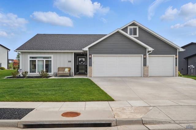 4553 Lahinch St, Rapid, SD 57702 - view of front of property featuring an attached garage, driveway, board and batten siding, a front lawn, and a shingled roof