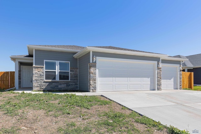 416 Henry Potter Rd, Box Elder, SD 57719 - view of front of property with driveway, an attached garage, and stone siding