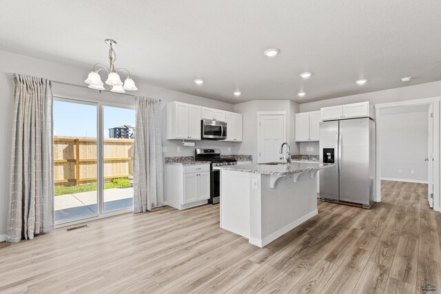 416 Henry Potter Rd, Box Elder, SD 57719 - kitchen with appliances with stainless steel finishes, light wood finished floors, a chandelier, white cabinets, and recessed lighting