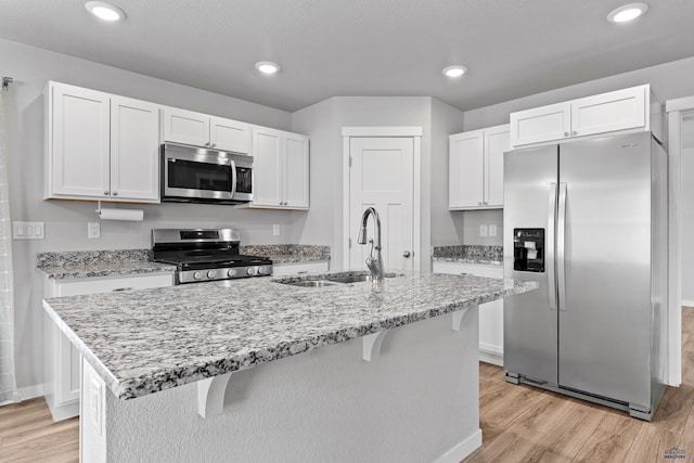 416 Henry Potter Rd, Box Elder, SD 57719 - kitchen featuring appliances with stainless steel finishes, a sink, light wood-type flooring, white cabinets, and recessed lighting