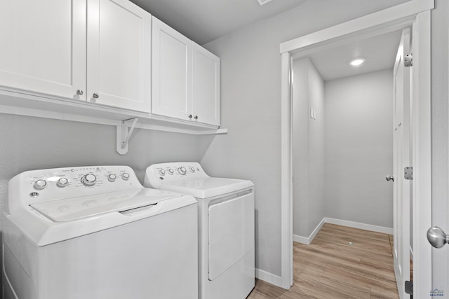 416 Henry Potter Rd, Box Elder, SD 57719 - laundry area featuring washing machine and dryer, cabinet space, light wood-style floors, and baseboards