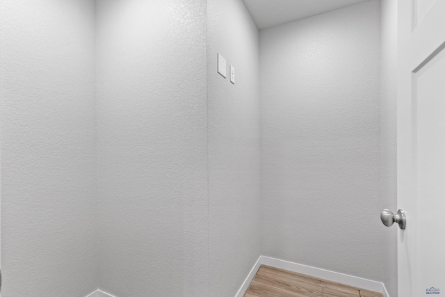 416 Henry Potter Rd, Box Elder, SD 57719 - washroom featuring baseboards and light wood-style flooring