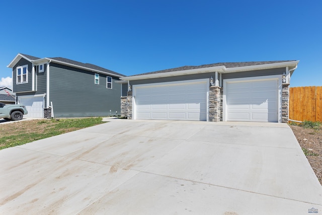 416 Henry Potter Rd, Box Elder, SD 57719 - view of front of property with stone siding, concrete driveway, and a garage