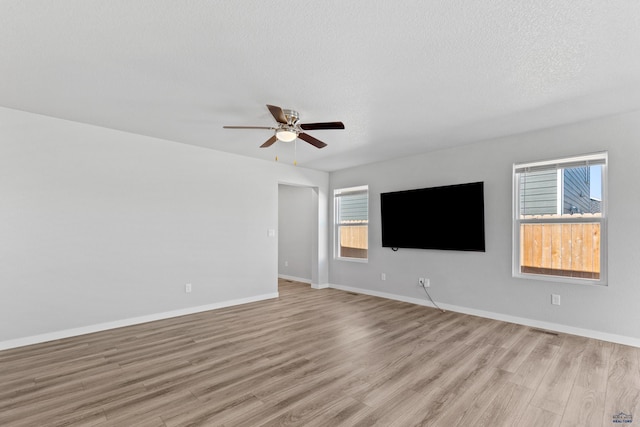 416 Henry Potter Rd, Box Elder, SD 57719 - unfurnished living room with a ceiling fan, light wood-type flooring, healthy amount of natural light, and baseboards