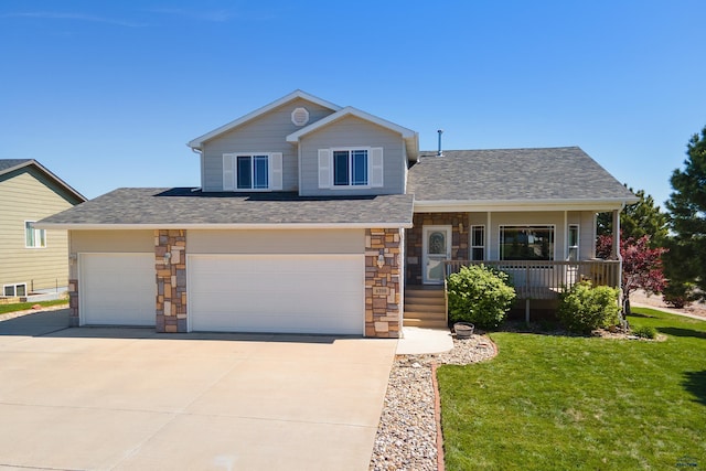 4300 Donegal Way, Rapid City, SD 57702 - view of front of property featuring a front lawn, covered porch, driveway, stone siding, and an attached garage