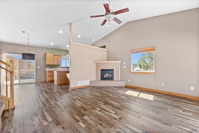 4300 Donegal Way, Rapid City, SD 57702 - unfurnished living room with ceiling fan, dark wood-style flooring, a tile fireplace, recessed lighting, and baseboards