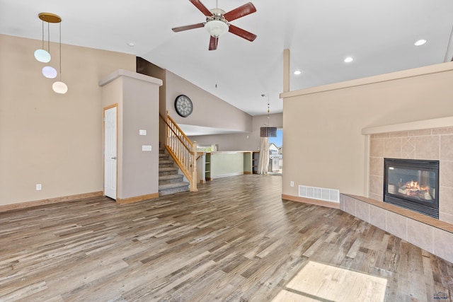 4300 Donegal Way, Rapid City, SD 57702 - unfurnished living room featuring ceiling fan, wood finished floors, baseboards, a tile fireplace, and recessed lighting