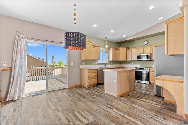 4300 Donegal Way, Rapid City, SD 57702 - kitchen with stainless steel appliances, a sink, light brown cabinetry, a center island, and light countertops