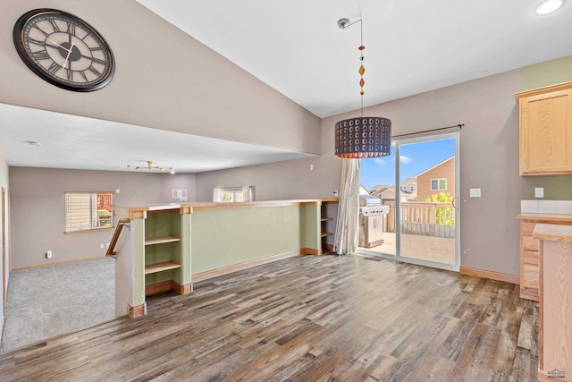 4300 Donegal Way, Rapid City, SD 57702 - unfurnished dining area featuring baseboards, wood finished floors, healthy amount of natural light, vaulted ceiling, and recessed lighting