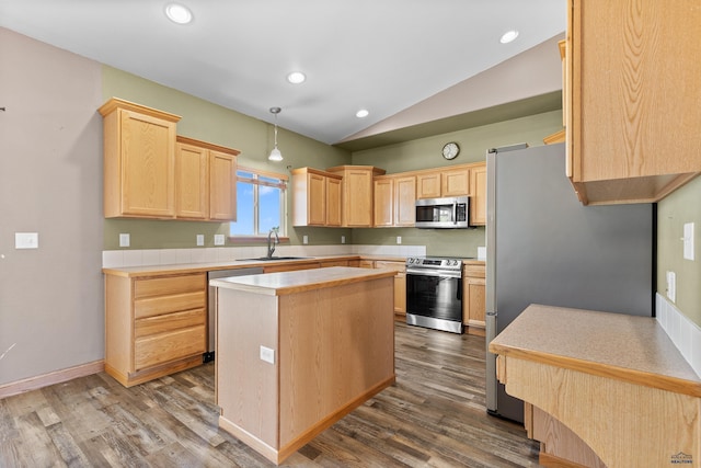 4300 Donegal Way, Rapid City, SD 57702 - kitchen featuring stainless steel appliances, light brown cabinets, vaulted ceiling, dark wood-type flooring, and light countertops