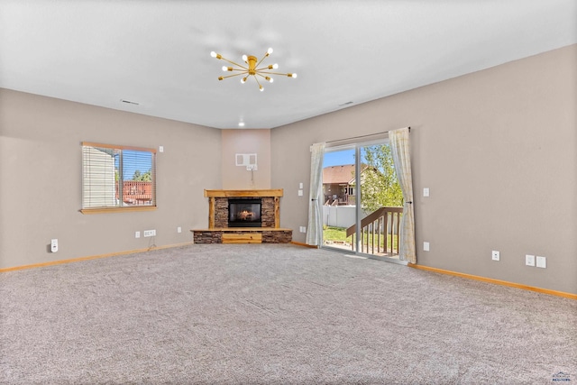 4300 Donegal Way, Rapid City, SD 57702 - unfurnished living room with baseboards, a stone fireplace, a chandelier, and carpet
